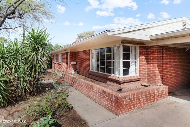 view of property exterior featuring brick siding