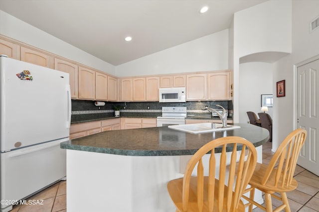 kitchen featuring a sink, light tile patterned floors, white appliances, and light brown cabinetry