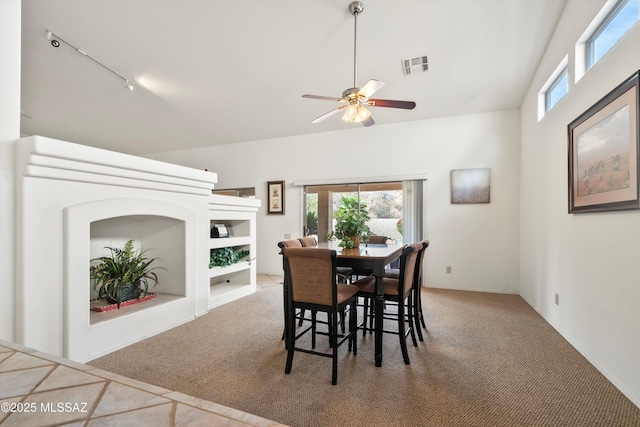 carpeted dining area featuring visible vents, a ceiling fan, and track lighting