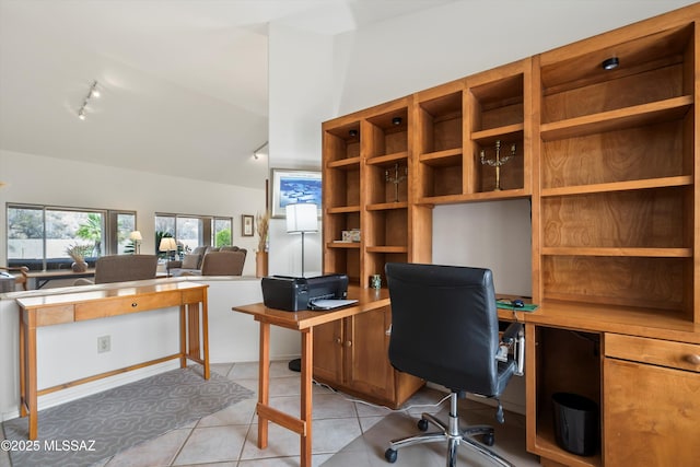 office space with light tile patterned floors, track lighting, and lofted ceiling
