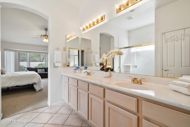 full bath featuring tile patterned floors, ensuite bathroom, a sink, and a ceiling fan
