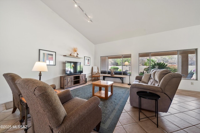 living room featuring track lighting, high vaulted ceiling, and tile patterned flooring