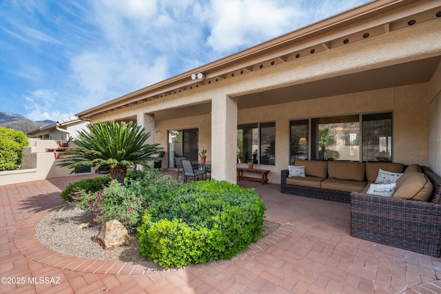 view of patio / terrace with an outdoor living space and a mountain view