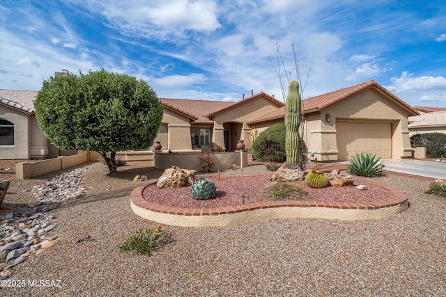 view of front of property with an attached garage, a tiled roof, driveway, and stucco siding