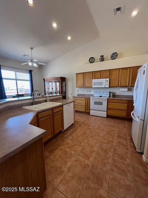 4769 S Meadow Ridge Dr, Green Valley, AZ 85622 - kitchen featuring white appliances, a sink, vaulted ceiling, a ceiling fan, and brown cabinetry