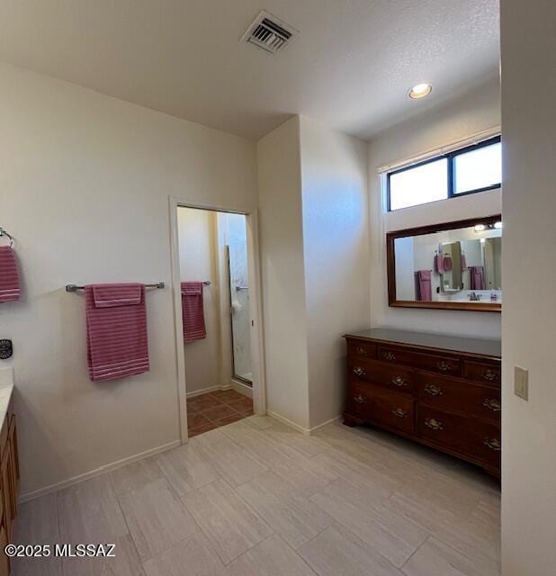 4769 S Meadow Ridge Dr, Green Valley, AZ 85622 - bathroom featuring vanity, a shower with door, and baseboards