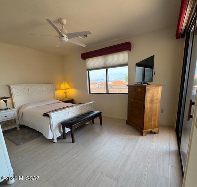 4769 S Meadow Ridge Dr, Green Valley, AZ 85622 - bedroom featuring light wood-style flooring, baseboards, and a ceiling fan