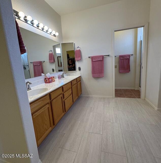 4769 S Meadow Ridge Dr, Green Valley, AZ 85622 - bathroom featuring a shower stall, tile patterned flooring, baseboards, and a textured wall