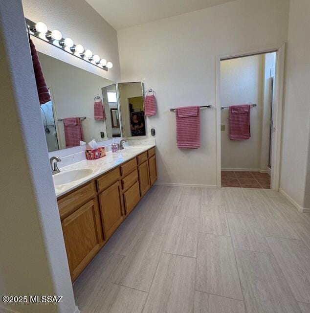 4769 S Meadow Ridge Dr, Green Valley, AZ 85622 - bathroom featuring double vanity, an enclosed shower, baseboards, and wood finished floors