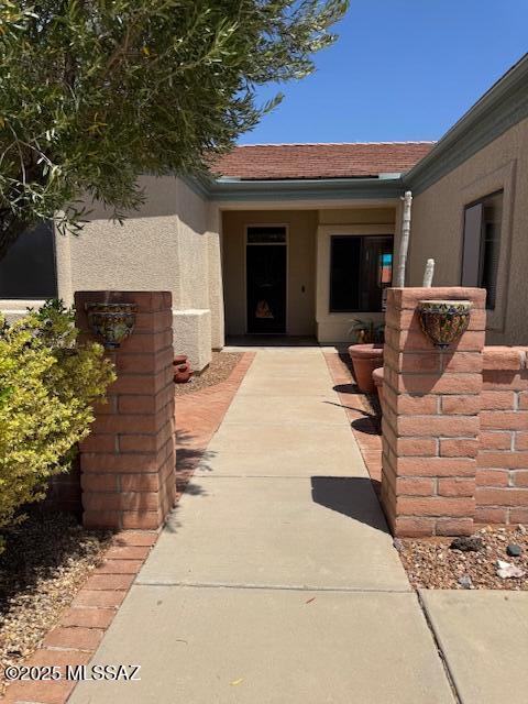 4769 S Meadow Ridge Dr, Green Valley, AZ 85622 - doorway to property with stucco siding