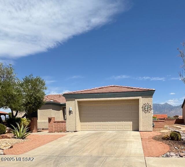 4769 S Meadow Ridge Dr, Green Valley, AZ 85622 - ranch-style home with stucco siding, driveway, and a garage