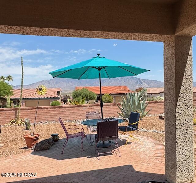 4769 S Meadow Ridge Dr, Green Valley, AZ 85622 - fenced backyard featuring a mountain view, a patio, and outdoor dining area