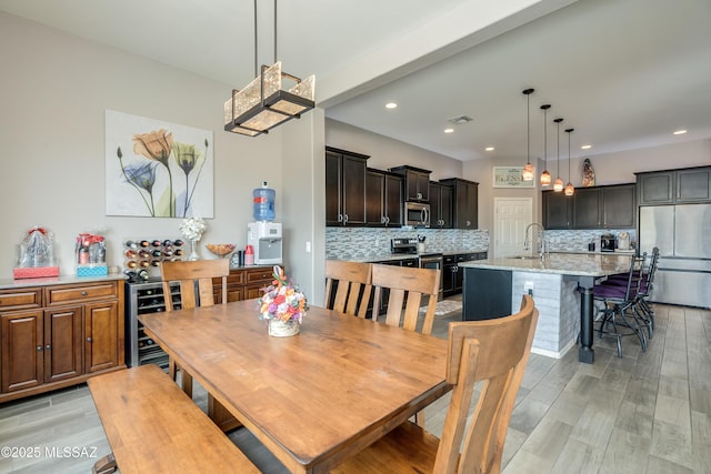 dining area featuring recessed lighting, light wood finished floors, and visible vents