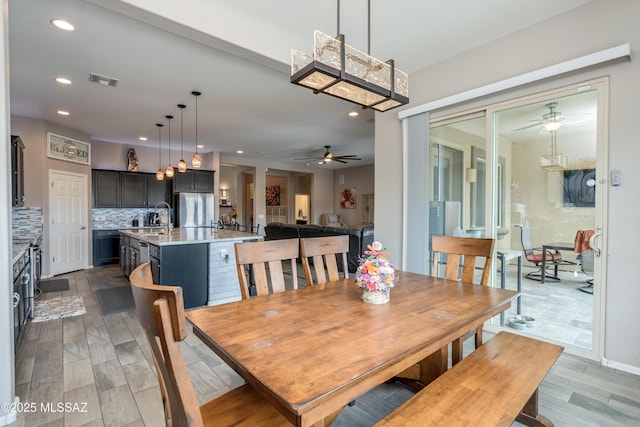 dining space with visible vents, a ceiling fan, wood finished floors, and recessed lighting