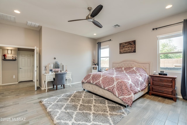bedroom with multiple windows and visible vents