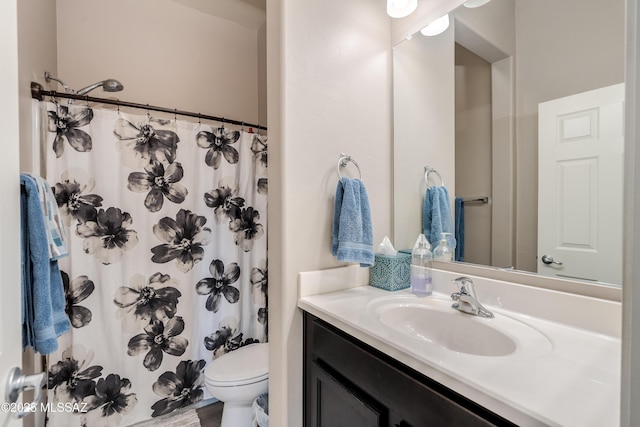 full bathroom with toilet, vanity, and a shower with curtain