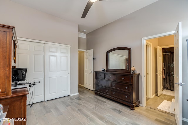 bedroom with light wood-style flooring, a closet, baseboards, and ceiling fan