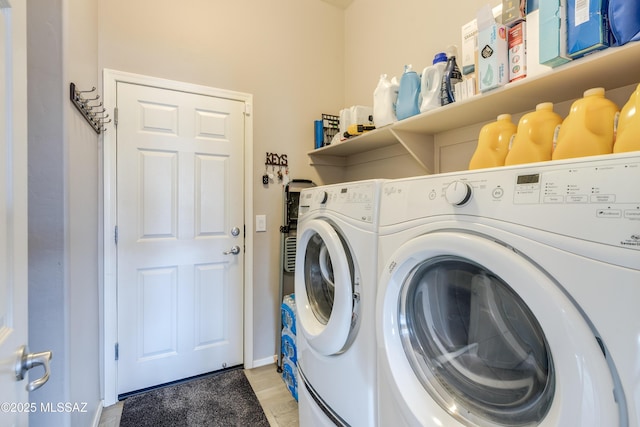 laundry room with light wood-style floors, washing machine and dryer, and laundry area