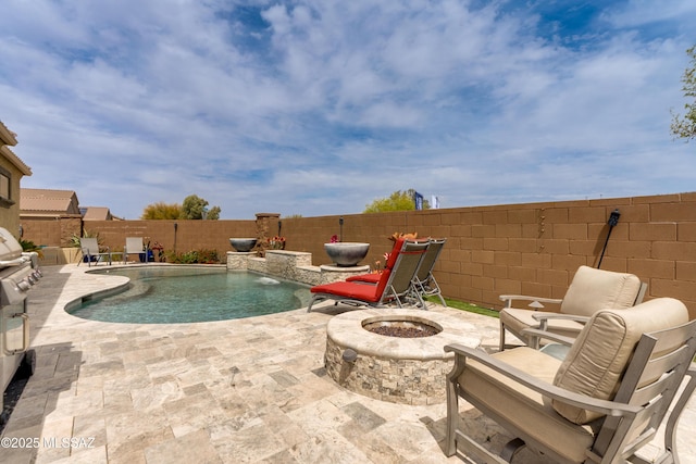 view of pool featuring a fenced in pool, a patio area, a fenced backyard, and a fire pit