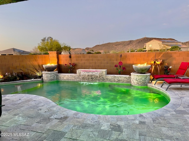 view of pool featuring a patio, a fenced backyard, and a fenced in pool