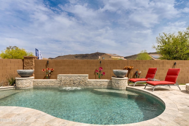 view of pool featuring a patio area, fence, and a fenced in pool