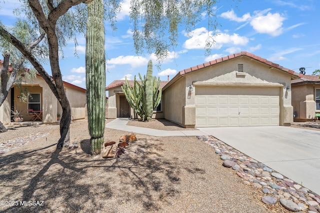 3398 W Sagebrush Hills Ct, Tucson, AZ 85741 - mediterranean / spanish-style home with an attached garage, stucco siding, a tiled roof, and concrete driveway