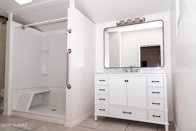 478 W Noon St, Nogales, AZ 85621 - bathroom featuring tile patterned floors, baseboards, a stall shower, and vanity