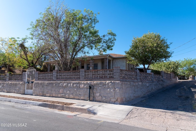 478 W Noon St, Nogales, AZ 85621 - view of front facade featuring a fenced front yard, a gate, and stone siding