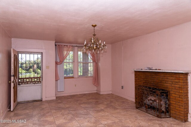478 W Noon St, Nogales, AZ 85621 - unfurnished living room featuring a chandelier, healthy amount of natural light, a fireplace, and baseboards