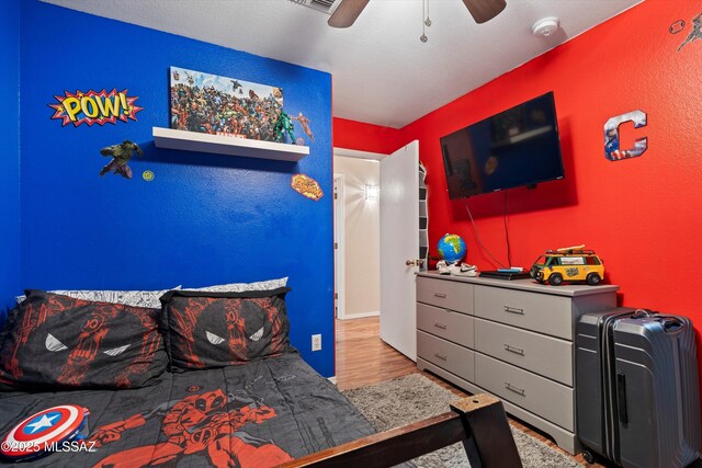 bedroom with a ceiling fan and wood finished floors