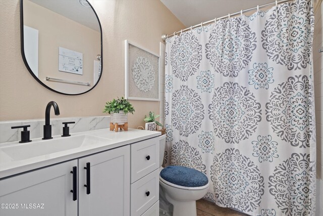 full bath featuring curtained shower, toilet, and vanity