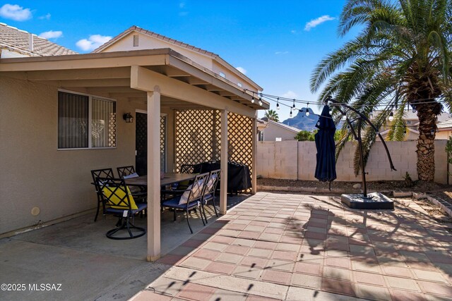 view of patio / terrace featuring fence and outdoor dining space