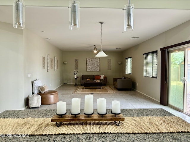 8754 W Denstone Rd, Marana, AZ 85653 - living room with light tile patterned flooring, plenty of natural light, and baseboards