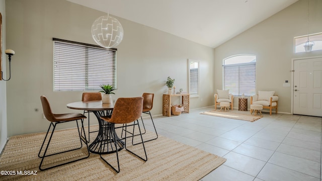 8754 W Denstone Rd, Marana, AZ 85653 - tiled dining space with high vaulted ceiling, baseboards, and a chandelier
