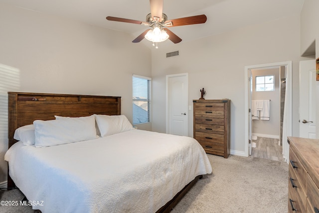 bedroom featuring visible vents, baseboards, ceiling fan, light carpet, and lofted ceiling