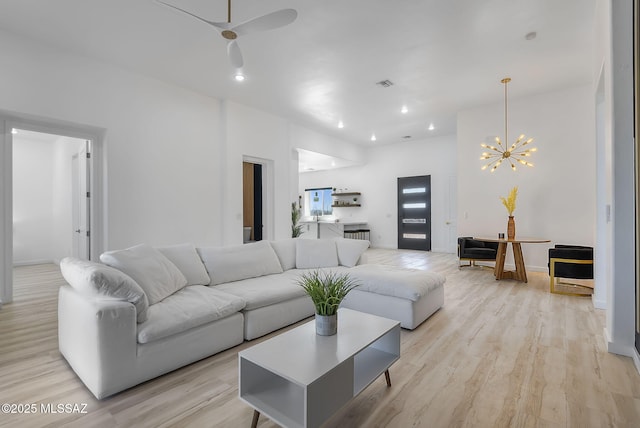 living area featuring recessed lighting, ceiling fan with notable chandelier, baseboards, light wood finished floors, and visible vents
