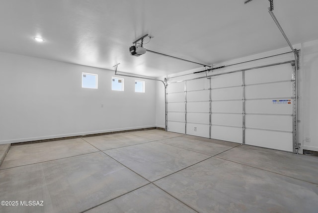 garage with baseboards and a garage door opener