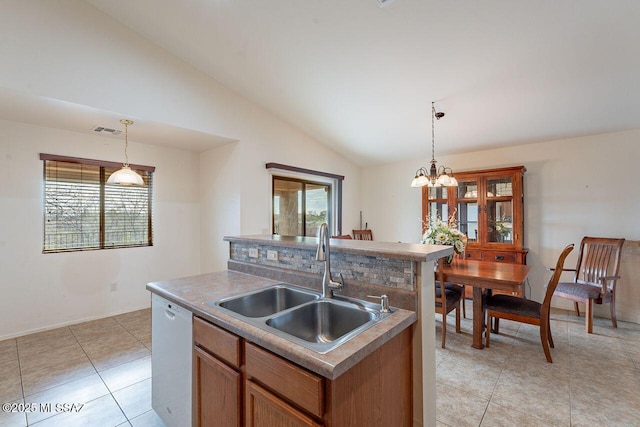 kitchen featuring vaulted ceiling, a sink, pendant lighting, white dishwasher, and visible vents