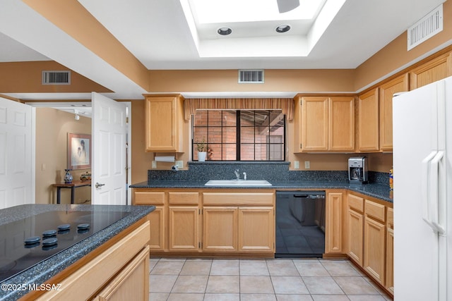 kitchen with black appliances, visible vents, and a tray ceiling