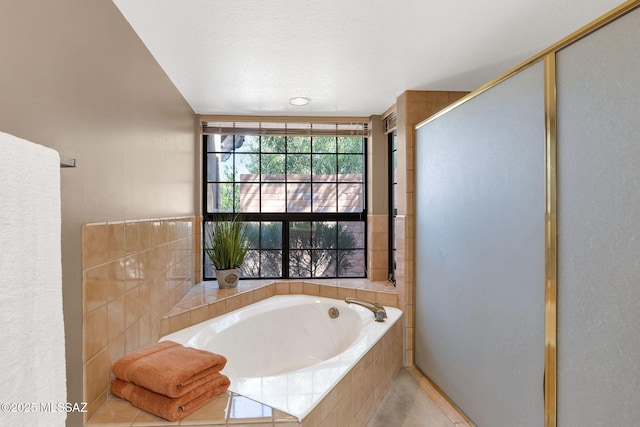 full bathroom with a shower stall and a garden tub