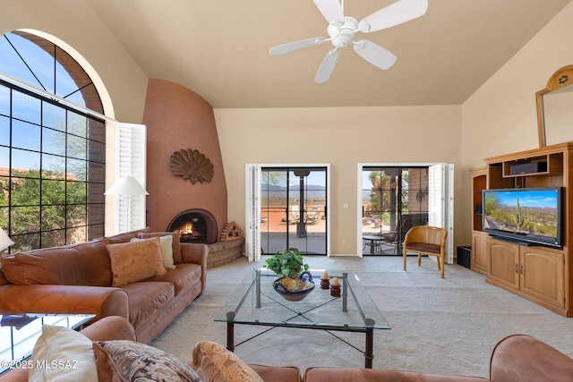 living room with ceiling fan, lofted ceiling, and light colored carpet