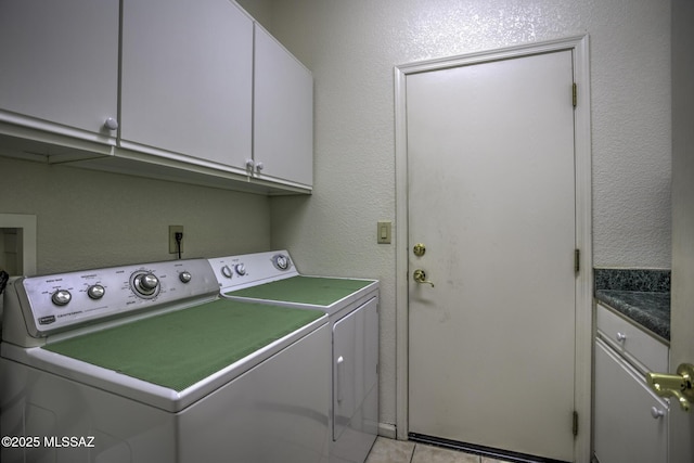 62583 E Amberwood Dr, Saddlebrooke, AZ 85739 - washroom featuring light tile patterned flooring, separate washer and dryer, cabinet space, and a textured wall