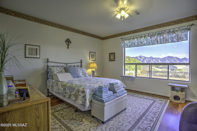 62583 E Amberwood Dr, Saddlebrooke, AZ 85739 - bedroom featuring baseboards, wood finished floors, and a mountain view