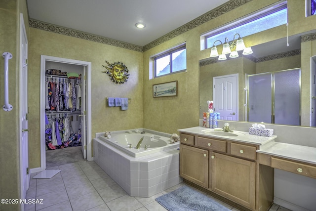 62583 E Amberwood Dr, Saddlebrooke, AZ 85739 - bathroom featuring a bath, a shower stall, tile patterned floors, vanity, and a walk in closet