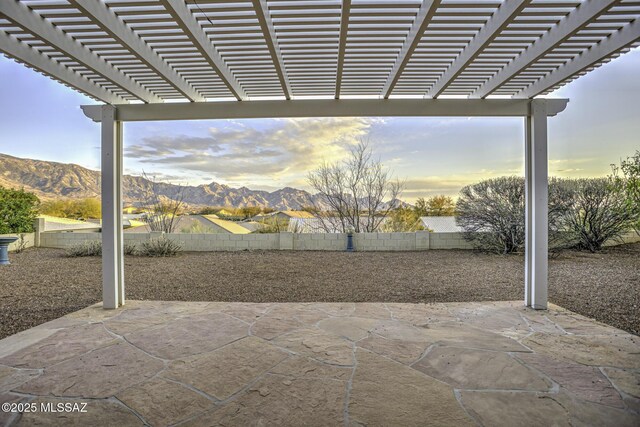 62583 E Amberwood Dr, Saddlebrooke, AZ 85739 - patio terrace at dusk with a mountain view and fence