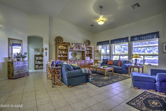 62583 E Amberwood Dr, Saddlebrooke, AZ 85739 - living area featuring visible vents, high vaulted ceiling, arched walkways, and light tile patterned floors