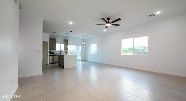 1686 Circulo Bahia, Rio Rico, AZ 85648 - unfurnished living room featuring a ceiling fan, recessed lighting, a sink, and baseboards