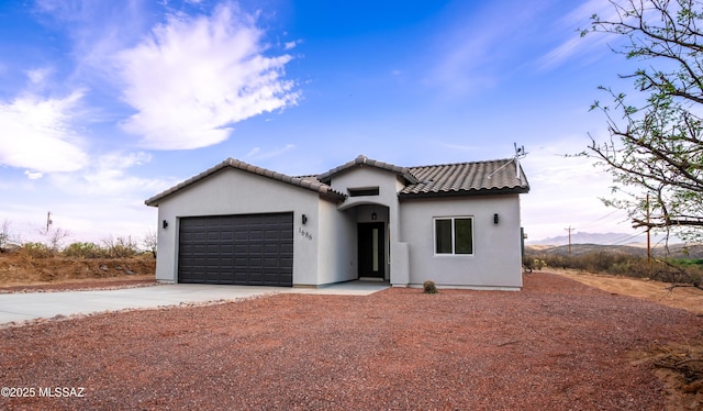 1686 Circulo Bahia, Rio Rico, AZ 85648 - view of front facade with driveway, an attached garage, stucco siding, and a tile roof