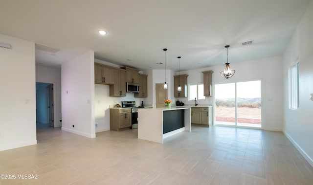 1686 Circulo Bahia, Rio Rico, AZ 85648 - kitchen featuring appliances with stainless steel finishes, light countertops, baseboards, a sink, and pendant lighting