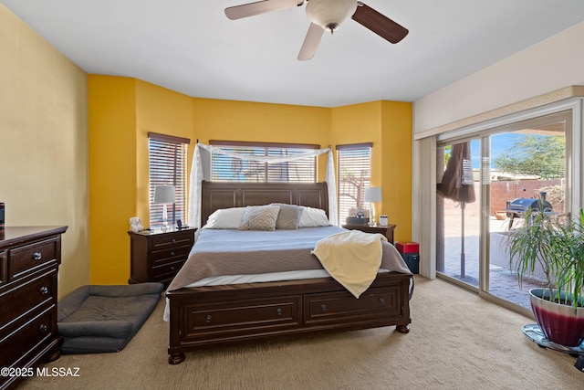 bedroom featuring access to exterior, multiple windows, ceiling fan, and light carpet